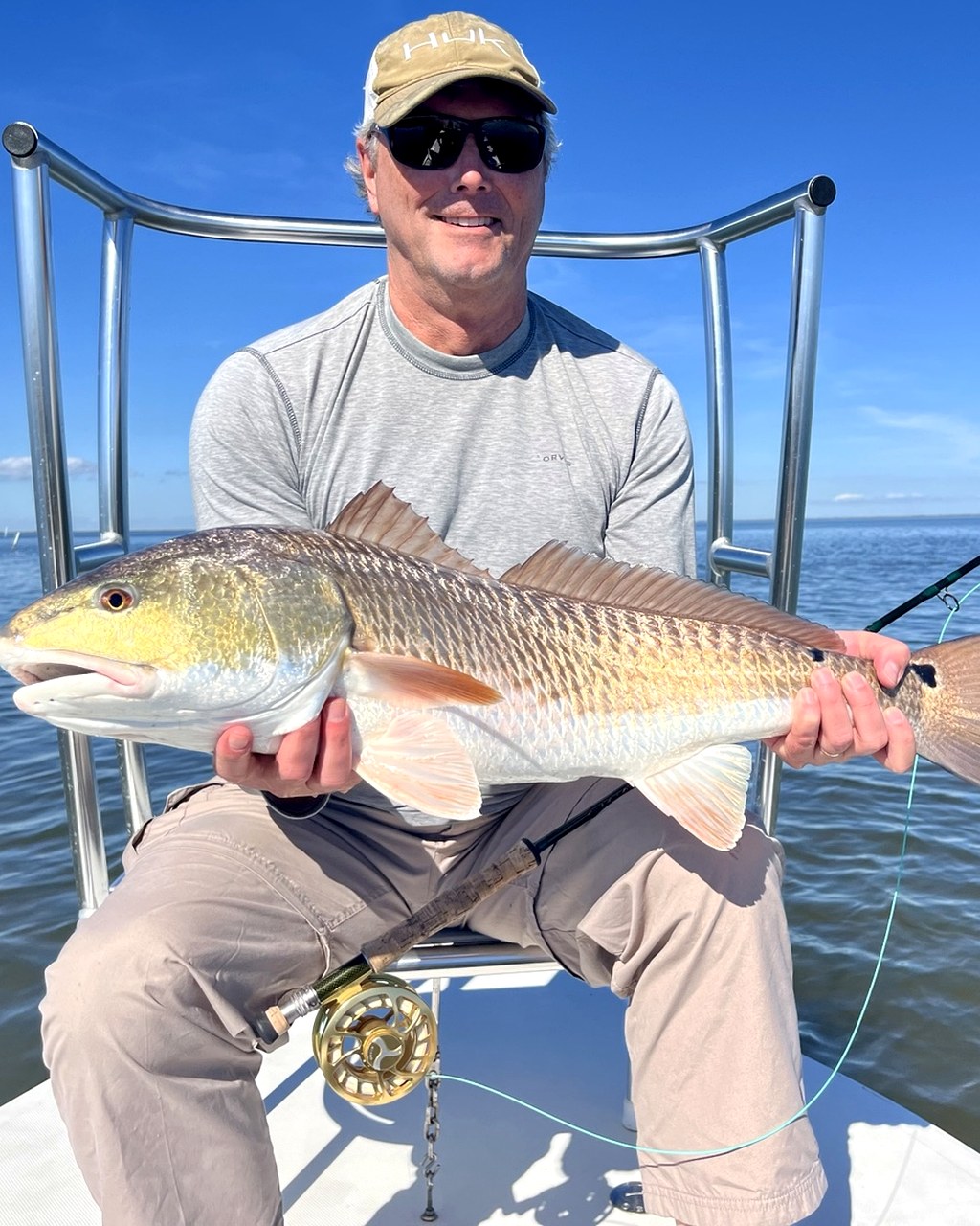 Owner-supplied photograph of an angler holding a redfish on Louisiana coastal water